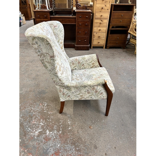 226 - A mid 20th century Parker Knoll PK750 beech and floral fabric upholstered wing back armchair