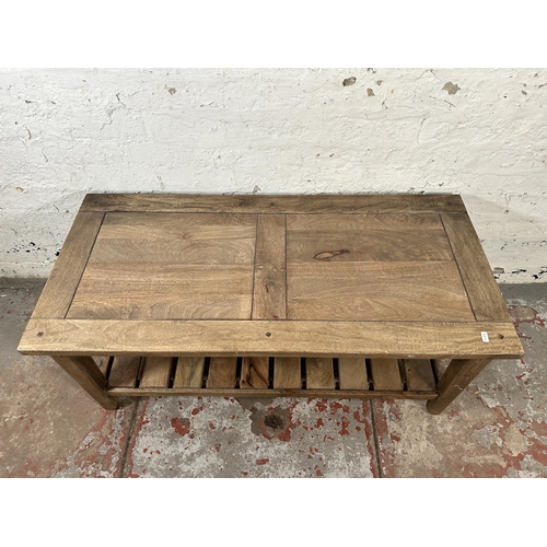 4 - A mango wood rectangular two tier coffee table - approx. 46cm high x 52cm wide x 110cm long