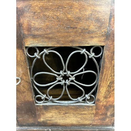 46 - An Indian hardwood and wrought metal bedside cabinet