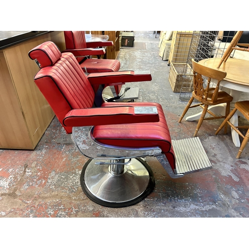 55 - A red leatherette and chrome plated adjustable swivel barber's chair