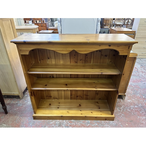 59 - A modern pine three tier bookcase - approx. 99cm high x 103cm wide x 29cm deep