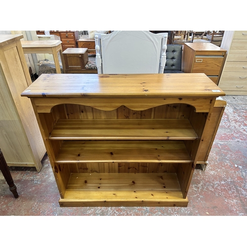 59 - A modern pine three tier bookcase - approx. 99cm high x 103cm wide x 29cm deep