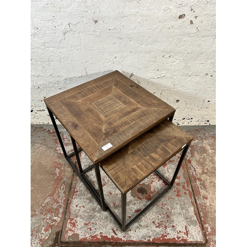 6 - A mango wood and black metal nest of tables - approx. 51cm high x 45cm wide x 45cm deep