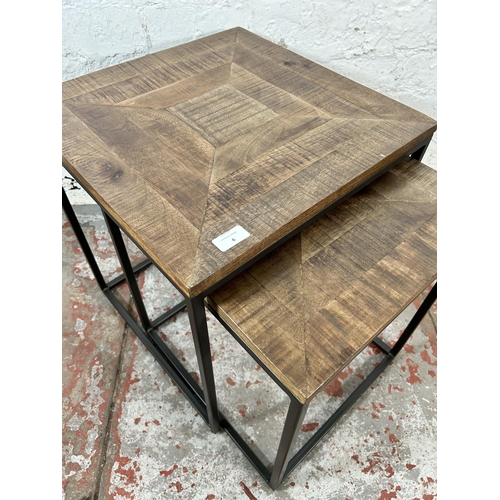 6 - A mango wood and black metal nest of tables - approx. 51cm high x 45cm wide x 45cm deep