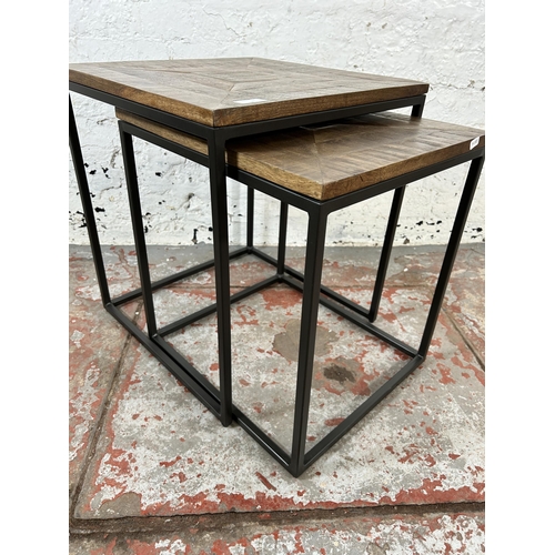 6 - A mango wood and black metal nest of tables - approx. 51cm high x 45cm wide x 45cm deep