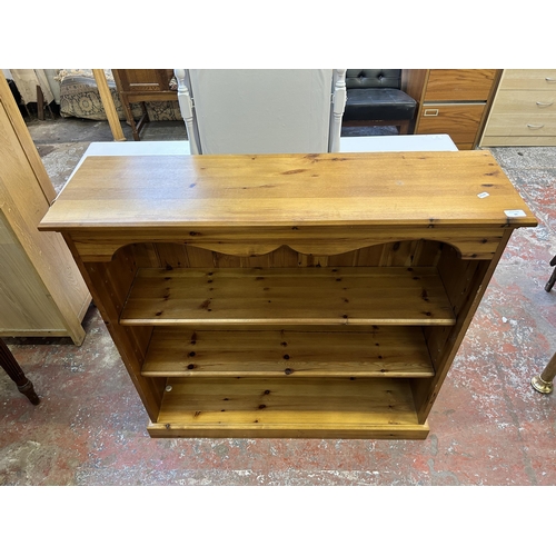 60 - A modern pine three tier bookcase - approx. 99cm high x 103cm wide x 29cm deep