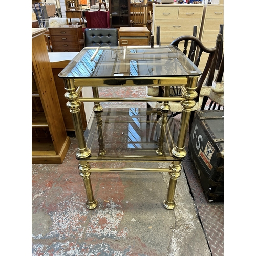 61 - A pair of brass and smoked glass side tables - approx. 44cm high x 60cm wide x 60cm deep