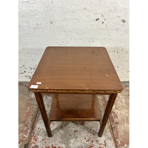 64 - A mid 20th century carved oak two tier side table