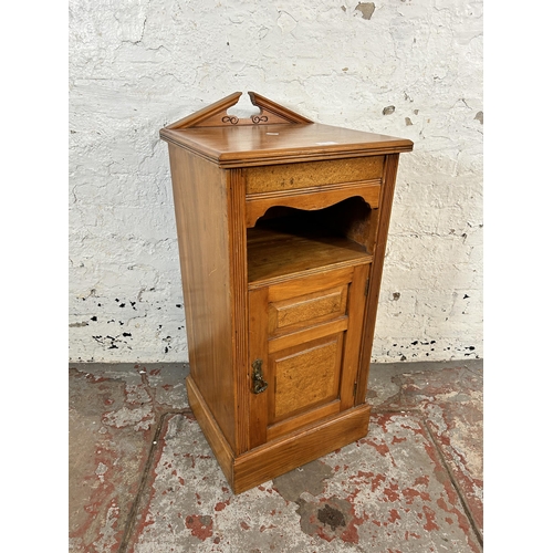 71 - An Edwardian satinwood and burr walnut bedside cabinet