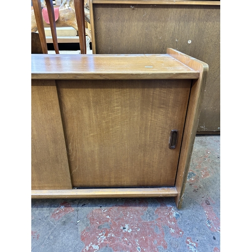 73 - A mid 20th century teak two door record cabinet - approx. 58cm high x 92cm wide x 48cm deep