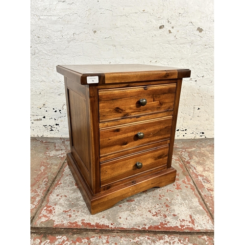 76 - A modern pine bedside chest of drawers