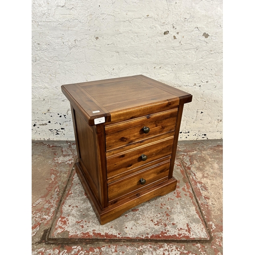 76 - A modern pine bedside chest of drawers