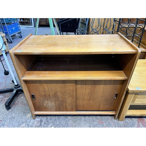 77 - A mid 20th century teak two door record cabinet - approx. 80cm high x 91cm wide x 48cm deep