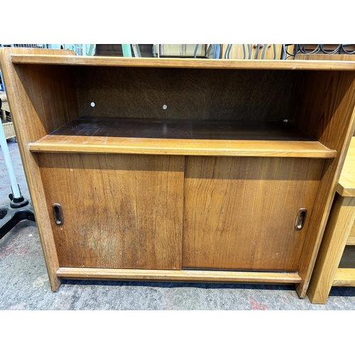 77 - A mid 20th century teak two door record cabinet - approx. 80cm high x 91cm wide x 48cm deep