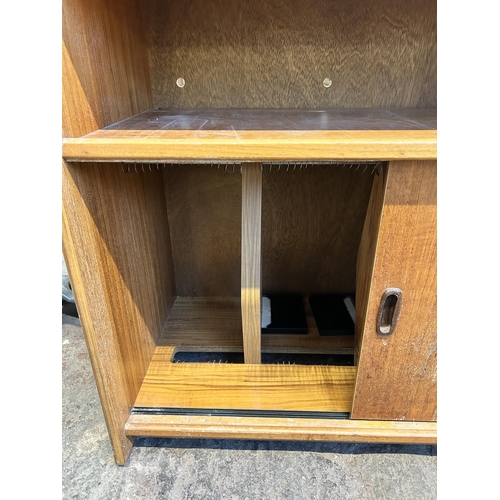 77 - A mid 20th century teak two door record cabinet - approx. 80cm high x 91cm wide x 48cm deep