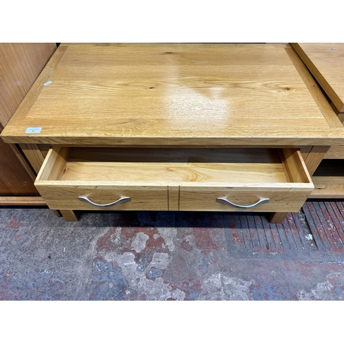 79 - A modern oak rectangular two tier coffee table - approx. 47cm high x 55cm wide x 90cm long