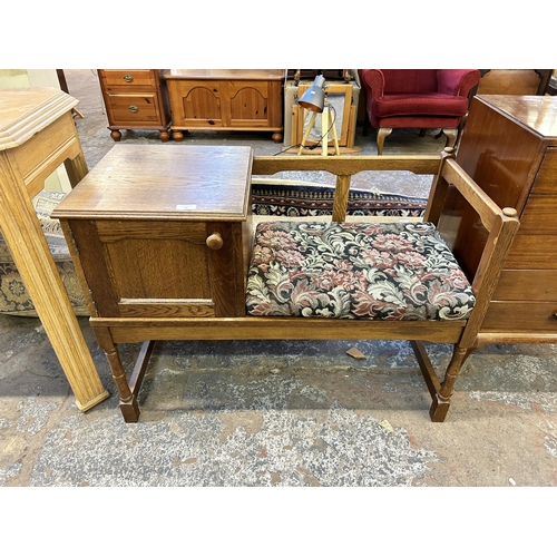 95 - An oak telephone table - approx. 66cm high x 91cm wide x 41cm deep