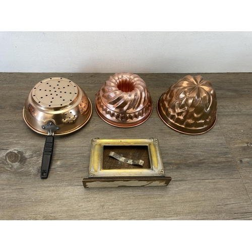 373 - A collection of metalware to include Victorian style copper jelly moulds, early 20th century oak and... 