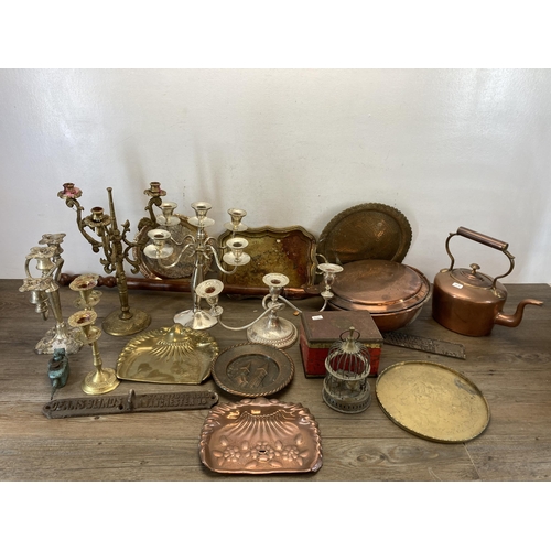 389 - A collection of metalware to include vintage brass three section candelabra, 19th century copper and... 