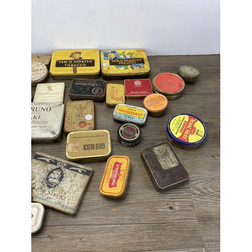 392 - A collection of vintage tins to include Craven 