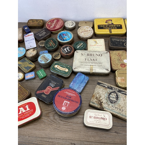 392 - A collection of vintage tins to include Craven 