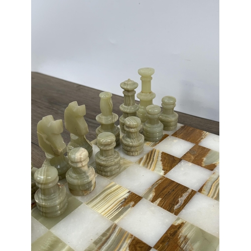 397 - A marble and onyx chess set - board approx. 31cm square