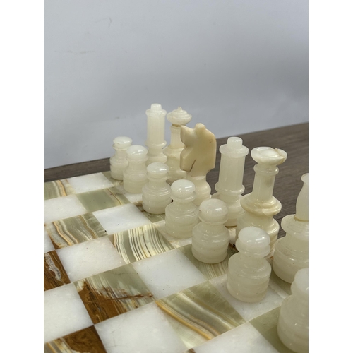 397 - A marble and onyx chess set - board approx. 31cm square