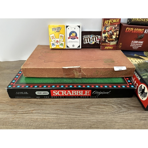 398 - A collection of board games to include Scrabble, Sushi Go Party!, Unstable Unicorns etc.