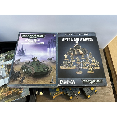 404 - A collection of Warhammer model making kits and accessories to include Astra Militarum Leman Russ Ba... 