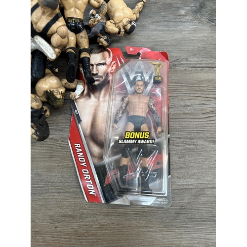 419 - A collection of WWE action figurines to include Randy Orton, Triple H, Vince McMahon, Matt Hardy etc... 