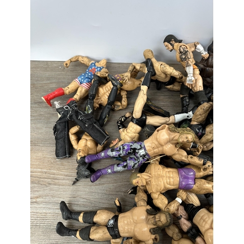 419 - A collection of WWE action figurines to include Randy Orton, Triple H, Vince McMahon, Matt Hardy etc... 