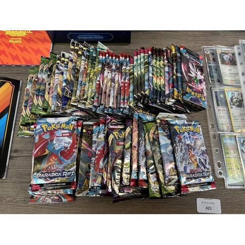 421 - A collection of Pokémon trading cards and accessories to include Dragonite VSTAR deck holder box, Sw... 