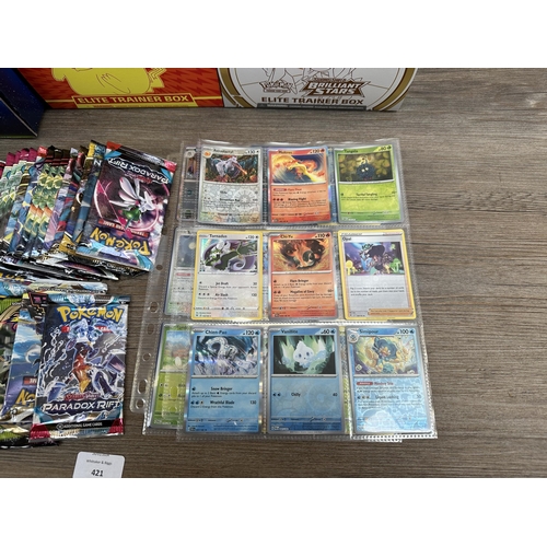 421 - A collection of Pokémon trading cards and accessories to include Dragonite VSTAR deck holder box, Sw... 