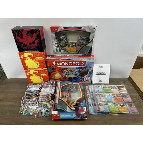 423 - A collection of Pokémon trading cards, games and accessories to include Pokémon Monopoly, Sword and ... 