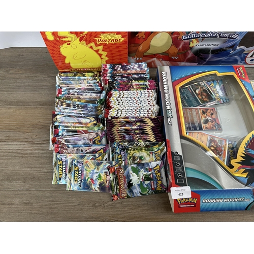 423 - A collection of Pokémon trading cards, games and accessories to include Pokémon Monopoly, Sword and ... 