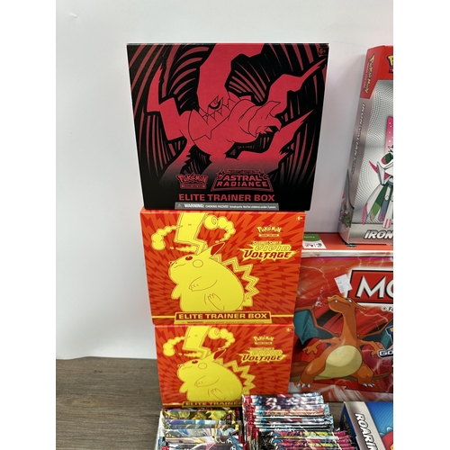 423 - A collection of Pokémon trading cards, games and accessories to include Pokémon Monopoly, Sword and ... 