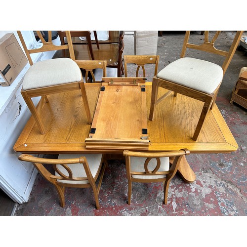 75A - A modern oak twin pedestal extending dining table and six chairs - approx. 78cm high x 100cm wide x ... 