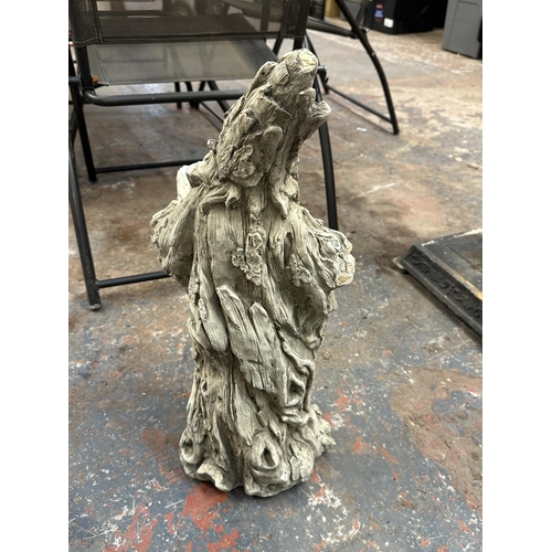 804 - A cast stone wizard garden statue - approx. 57cm high