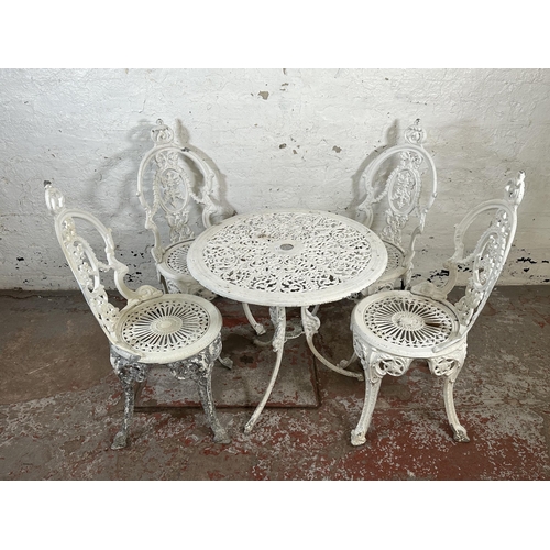 816 - A Victorian style white painted cast metal five piece patio set comprising circular table and four c... 