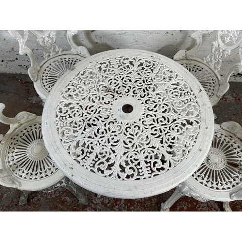 816 - A Victorian style white painted cast metal five piece patio set comprising circular table and four c... 