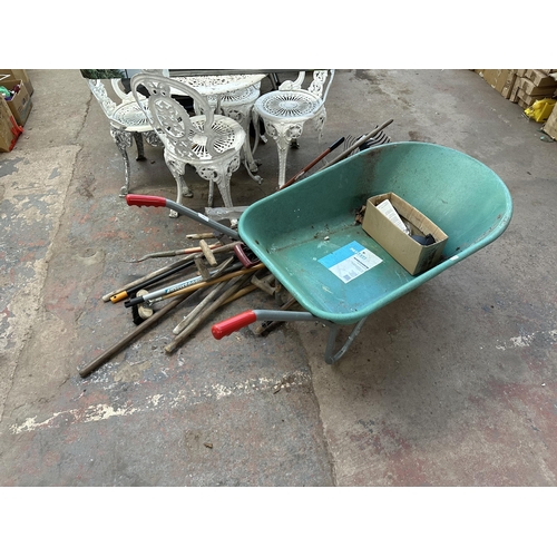 817 - A quantity of garden hand tools to include Focus 85L wheelbarrow etc.