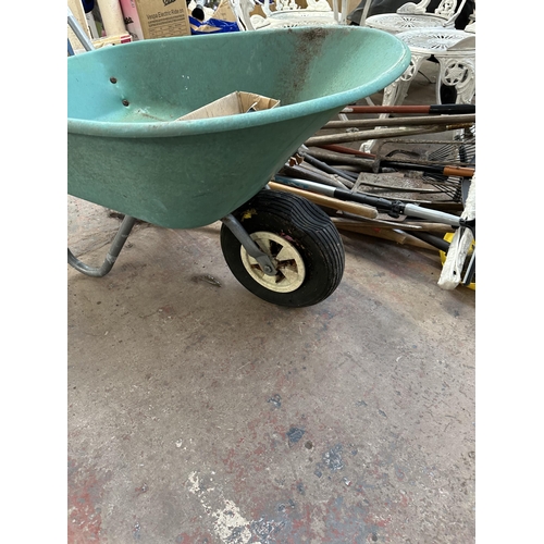 817 - A quantity of garden hand tools to include Focus 85L wheelbarrow etc.