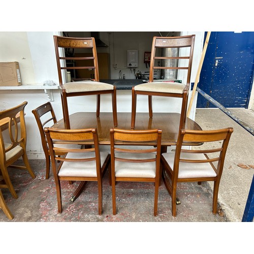 75B - A mahogany and burr walnut twin pedestal extending dining table and six chairs