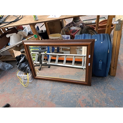 818 - A large collection of house clearance items to include mahogany framed bevelled edge wall mirror, tw... 