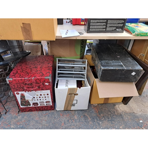 836 - A large collection of house clearance items to include two wired metal bottle racks, ceramic meat pl... 