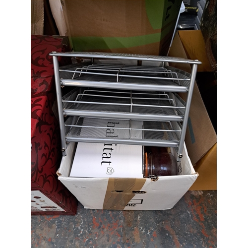 836 - A large collection of house clearance items to include two wired metal bottle racks, ceramic meat pl... 