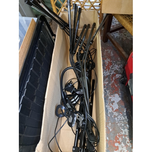 836 - A large collection of house clearance items to include two wired metal bottle racks, ceramic meat pl... 