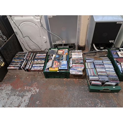 875 - Ten boxes containing a large collection of DVDs and CDs