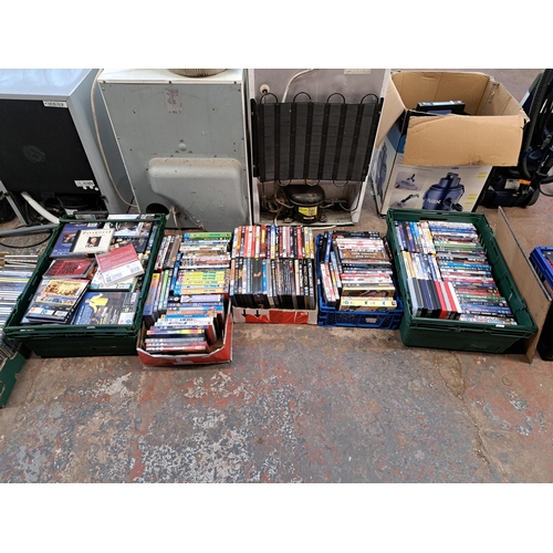 875 - Ten boxes containing a large collection of DVDs and CDs