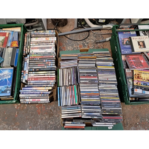 875 - Ten boxes containing a large collection of DVDs and CDs